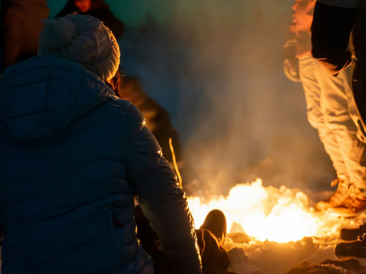 Gezin bij een kampvuur in de sneeuw in de nacht
